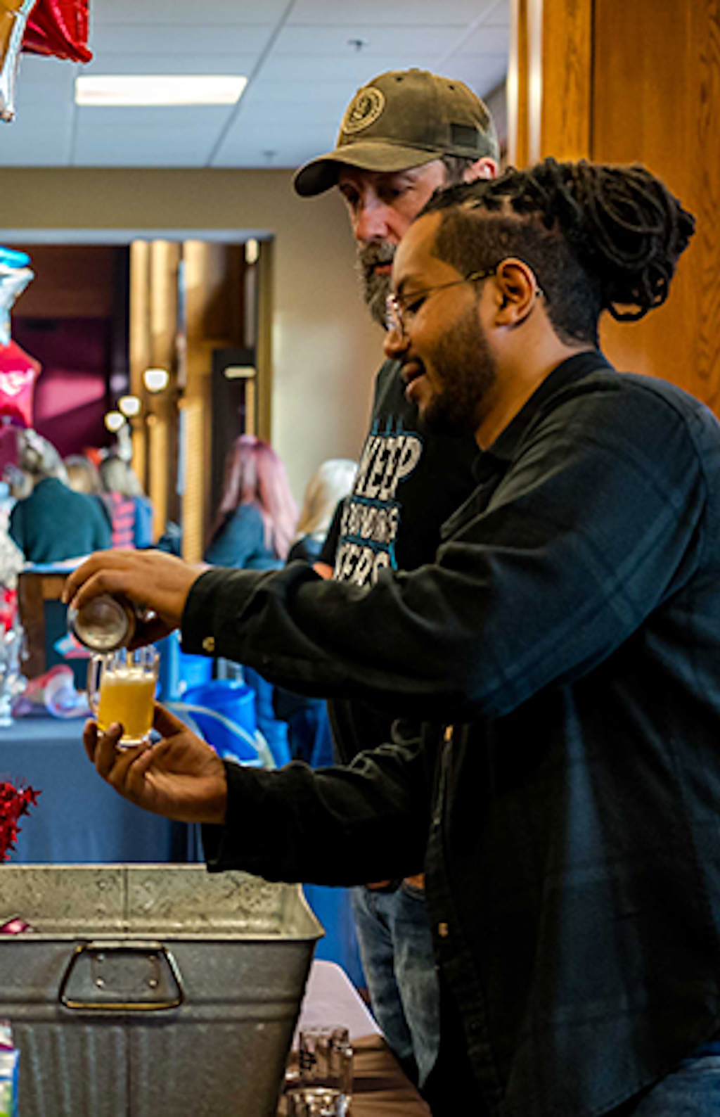 A vendor pouring a beer at the Beer & Wine Festival.